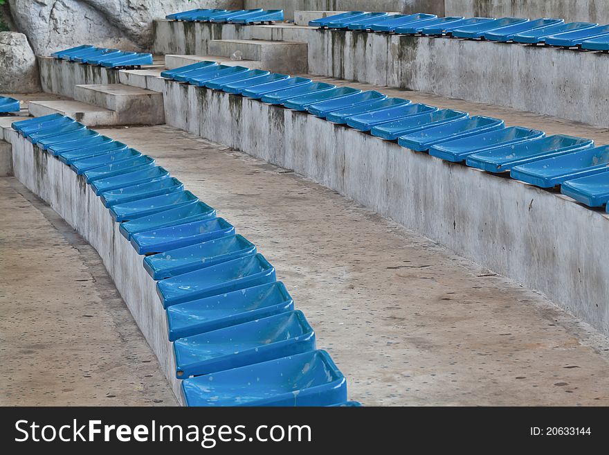Old plastic blue seats on stadium