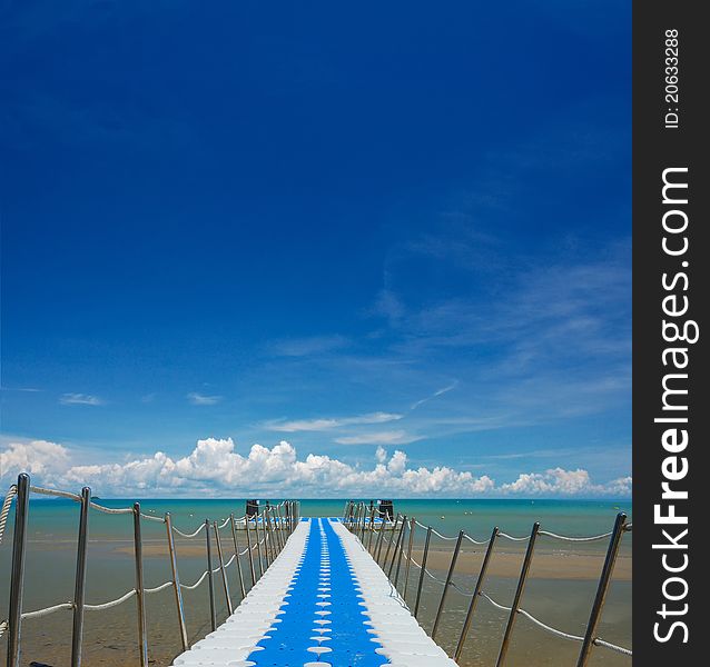 Perspective line of bridge to the sea on nice sky.