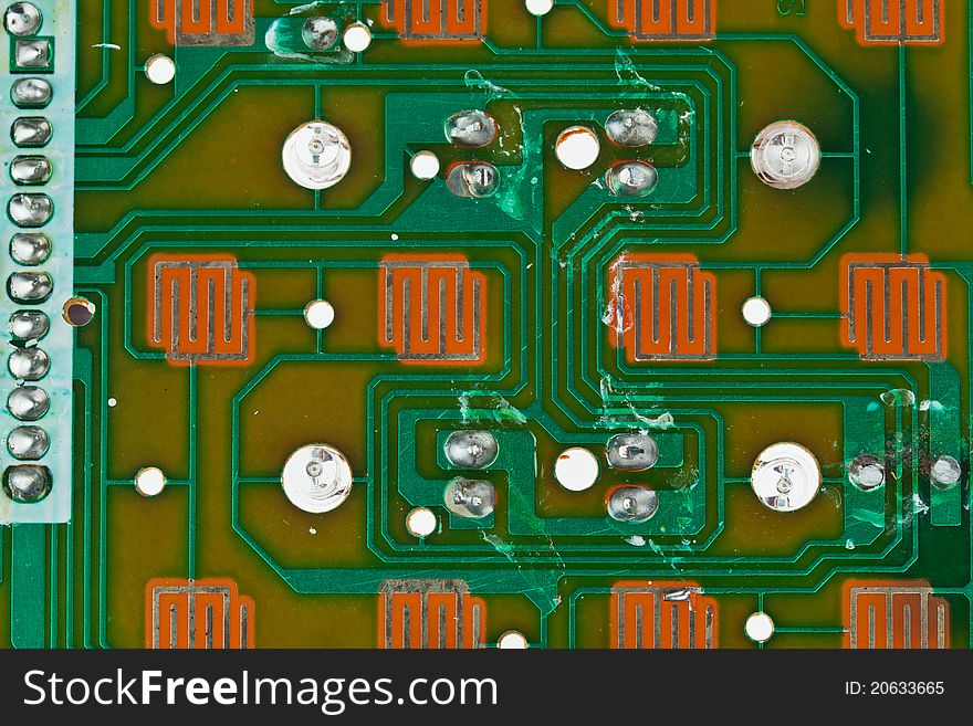 The modern printed-circuit board with electronic components macro background. The modern printed-circuit board with electronic components macro background