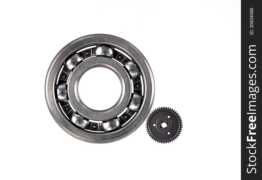 A bearing and gear cog isolated against a white background. A bearing and gear cog isolated against a white background