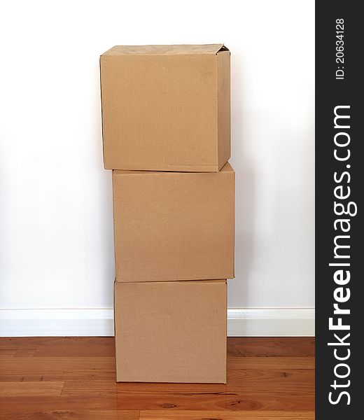 Cardboard boxes on a wooden floor. Cardboard boxes on a wooden floor