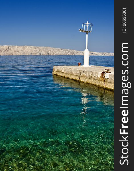 Beautiful emerald waters and coast with the pier and lighthouse. Beautiful emerald waters and coast with the pier and lighthouse