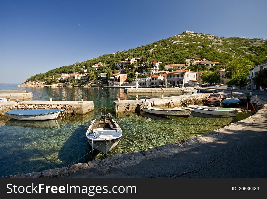 Small green water port and the fishing boats. Small green water port and the fishing boats