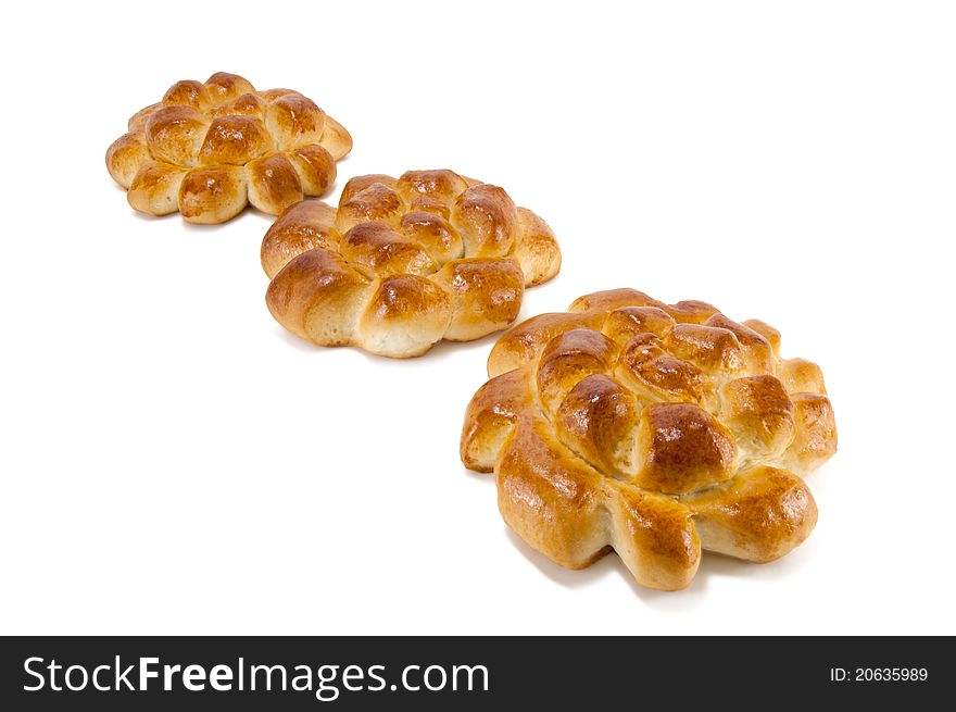 Three delightful baked rolls on a white background. Three delightful baked rolls on a white background