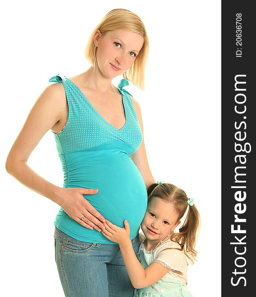 Cute girl embracing her pregnant mother
