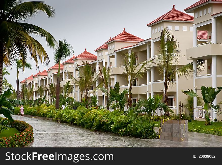 Street in a Dominican republic hotel with beige houses in summer