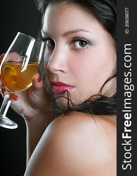 Beautiful girl with wine glass on black background