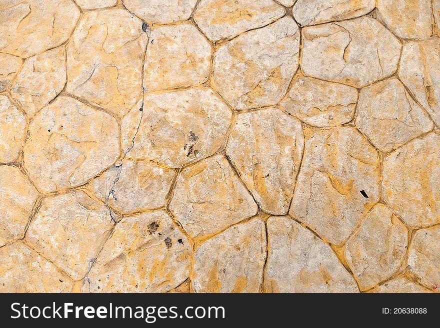 Beige background of stone texture wall in daylight
