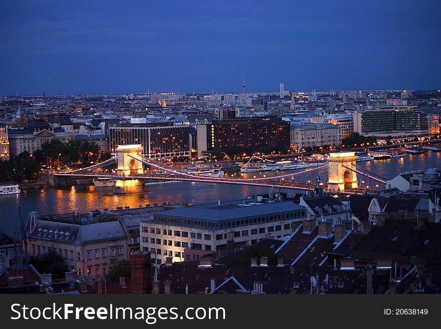 The Chain Bridge is a suspension bridge that spans the River Danube between Buda and Pest, the west and east side of Budapest, the capital of Hungary. The Chain Bridge is a suspension bridge that spans the River Danube between Buda and Pest, the west and east side of Budapest, the capital of Hungary