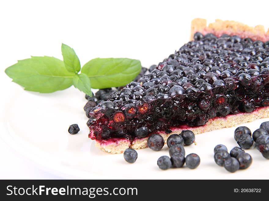 Blueberry Tart: a portion on a plate decorated with mint