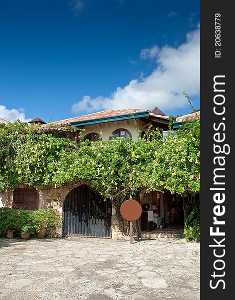 Old style Dominican eating house with green trees under blue sky