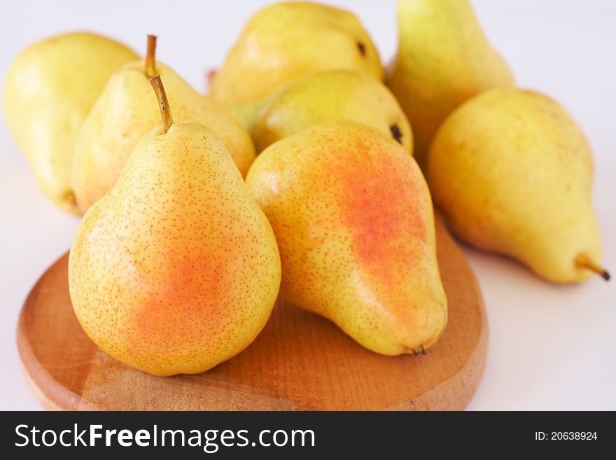 Ripe yellow pears on white background