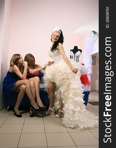 Bride with girlfriend in professional fashion designer studio