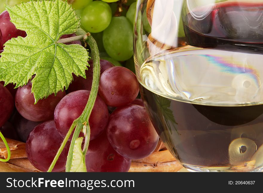 Red and white wine, with bunches of grapes, closeup photo