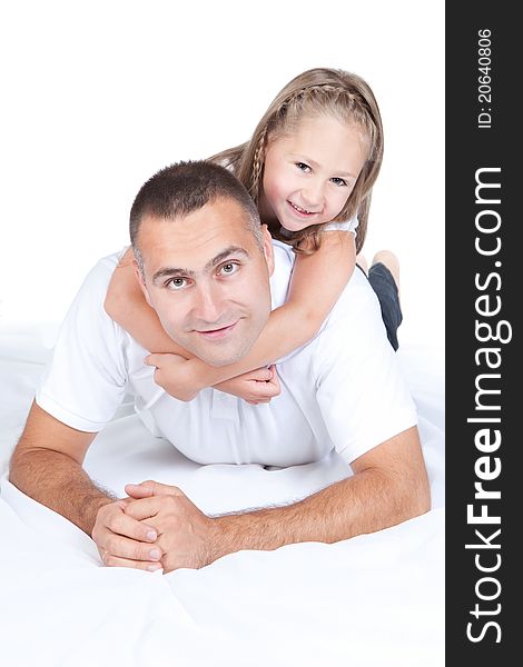 Father And Little Daughter Lying On A Bed