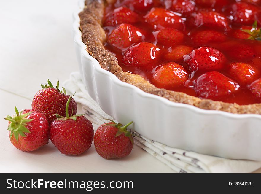 Sweet strawberry pie on a white table. Sweet strawberry pie on a white table