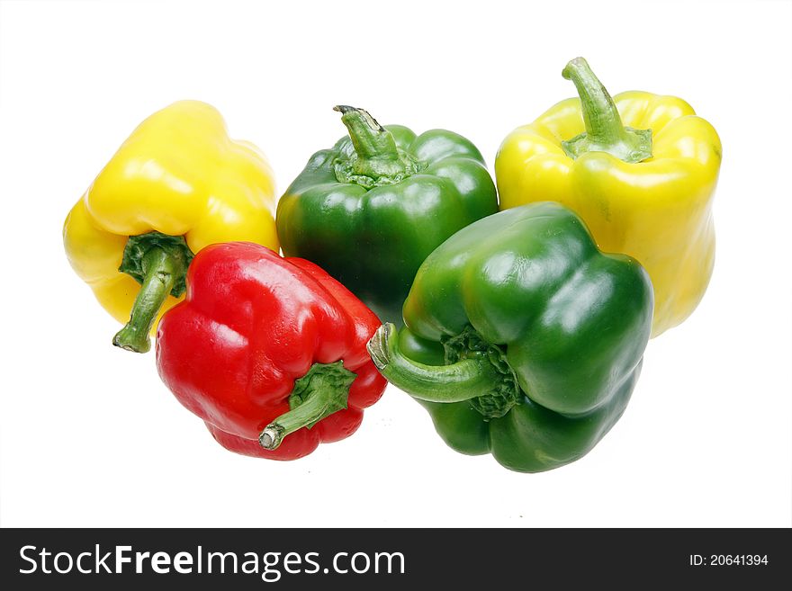 Three colors of sweet peppers on white.