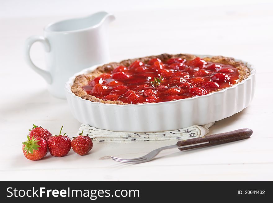 Sweet strawberry pie on a white table. Sweet strawberry pie on a white table