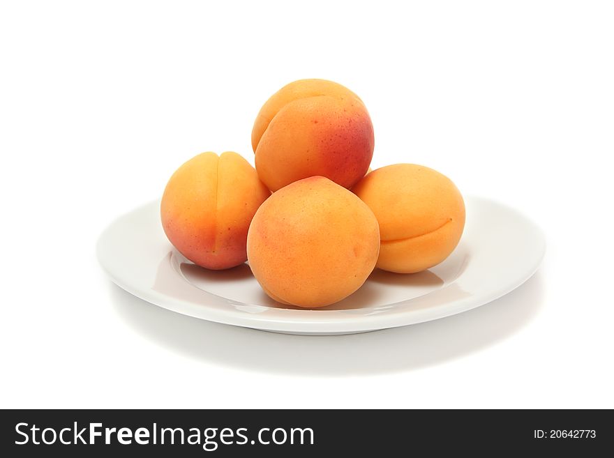 Ripe apricots on white plate. Ripe apricots on white plate