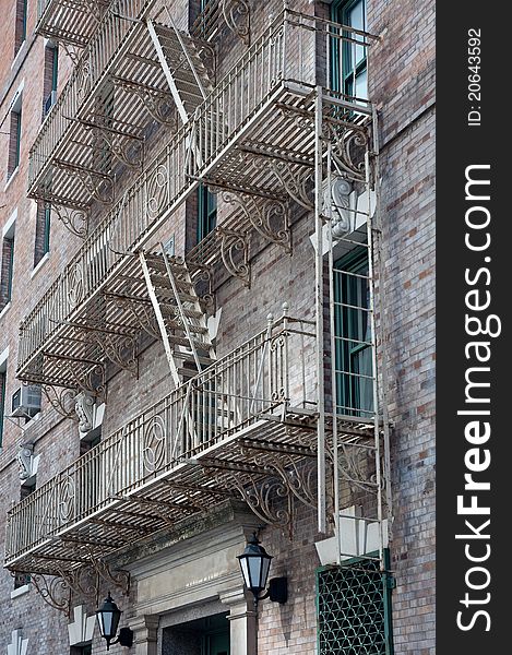 Typical American style fire escapes in a street of downtown Manhattan, New York City. Typical American style fire escapes in a street of downtown Manhattan, New York City.