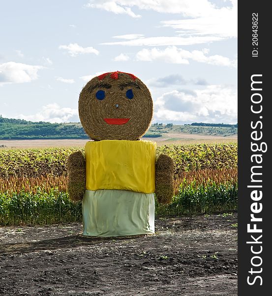 Huge straw woman staying on the field