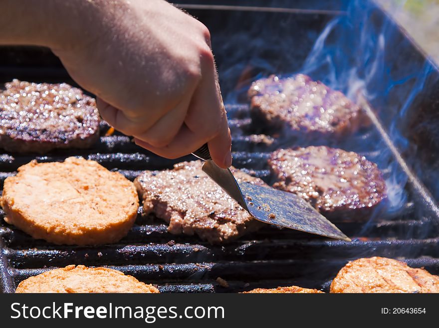 Hamburgers being flame broiled on the gas grill