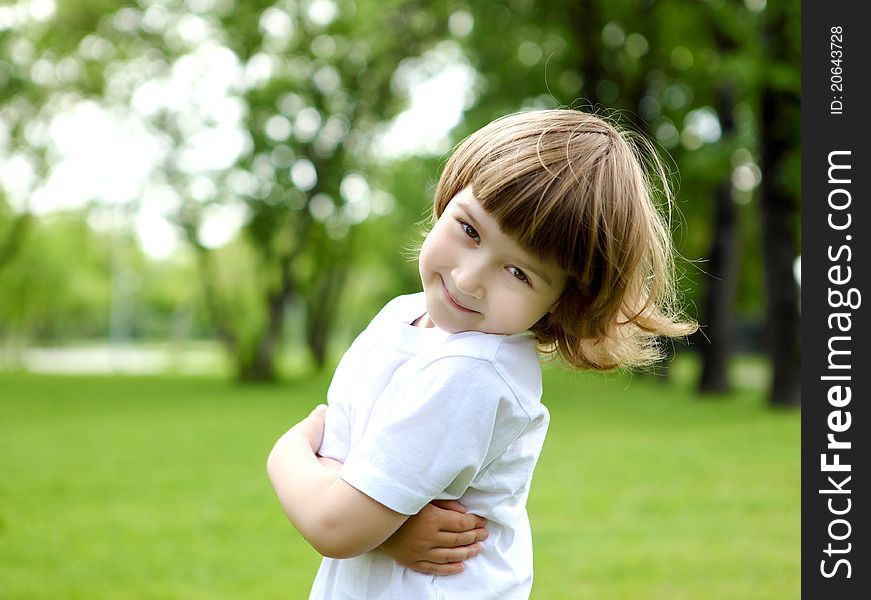 Portrait of a happy little girl outdoors in summer. Portrait of a happy little girl outdoors in summer