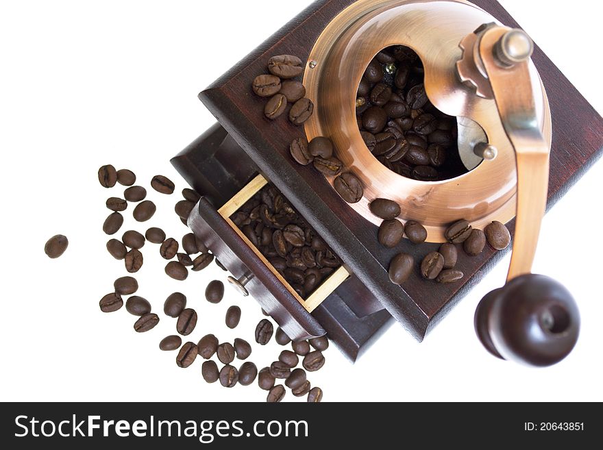 Coffee grinder with coffee beans on white