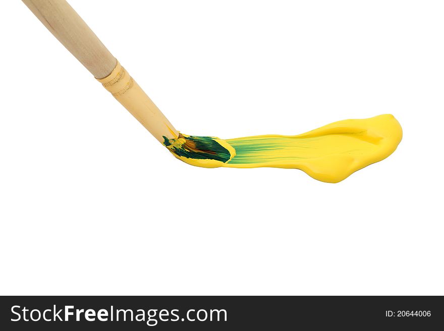Paintbrush with yellow paint isolated on white background