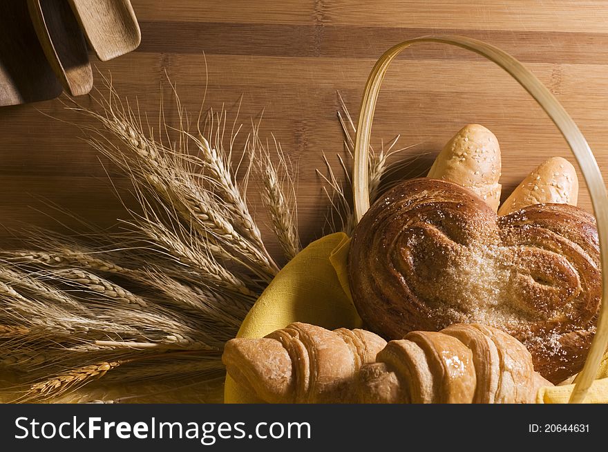 Sweet bread food in a basket over wood background