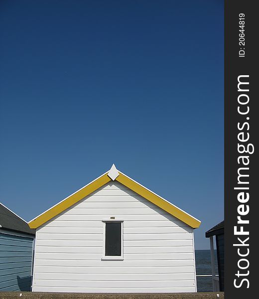 Yellow and white beach hut on sunny day in Southwold, Suffolk, England, UK. Yellow and white beach hut on sunny day in Southwold, Suffolk, England, UK