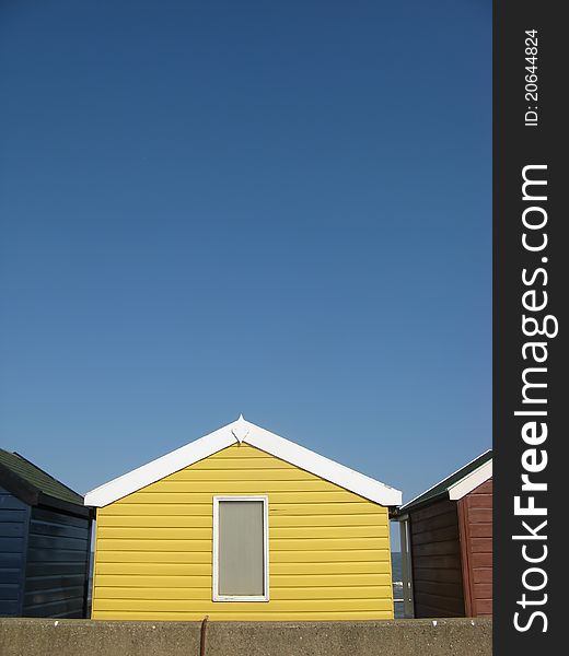 Bright Yellow Beach Hut On An English Beach