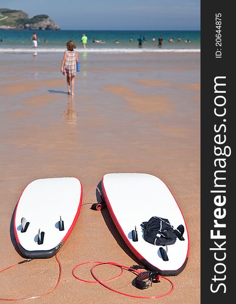 Two surfboards on the beach sand