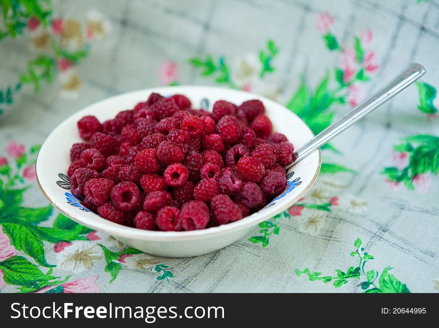 Fresh summer red raspberry in the plate at home. Fresh summer red raspberry in the plate at home