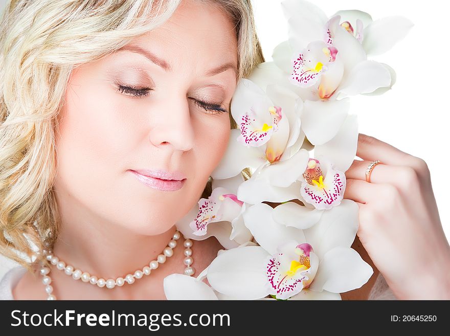 Close-up portrait of beautiful young blonde woman with  flowers  of orchid on isolated white background. Close-up portrait of beautiful young blonde woman with  flowers  of orchid on isolated white background