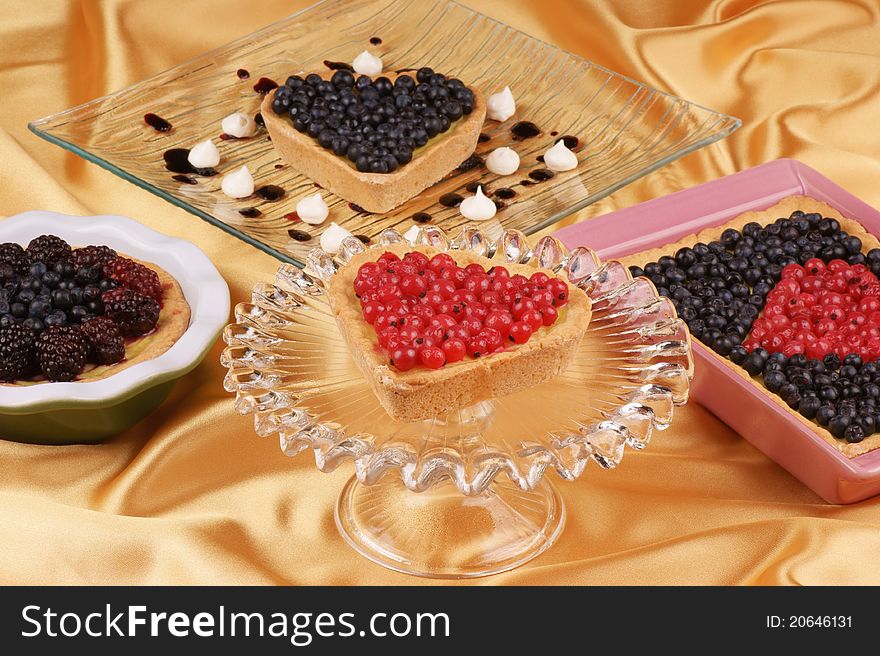 Assorted tarts with blueberries, redcurrants and raspberries. Selective focus, shallow DOF. Assorted tarts with blueberries, redcurrants and raspberries. Selective focus, shallow DOF