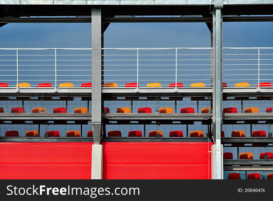Sport stadium or tribune architecture with colorful empty seats, abstract background. Sport stadium or tribune architecture with colorful empty seats, abstract background.