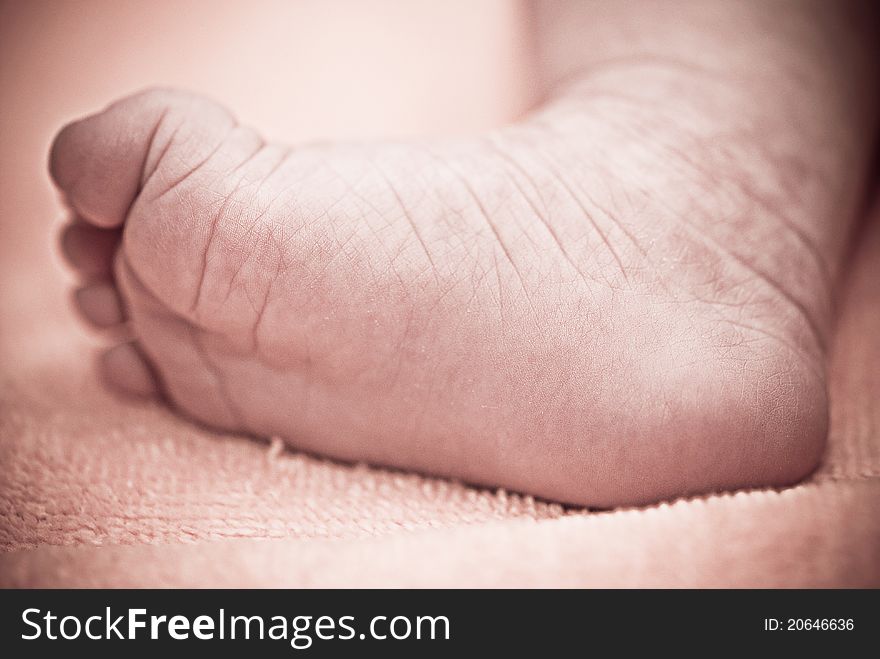 Baby's foot in mother hands closeup. Baby's foot in mother hands closeup