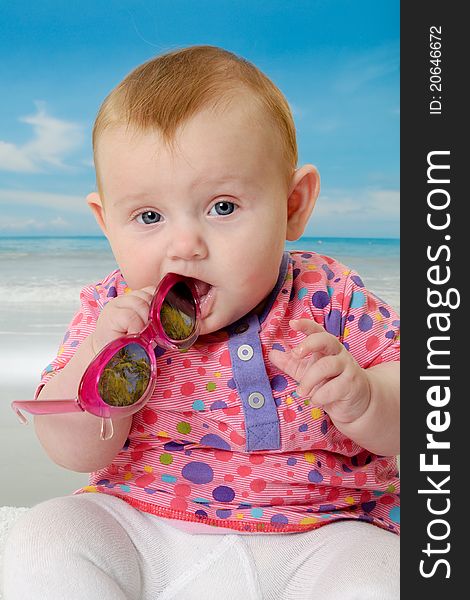 Sweet baby on vacation on beach with the sea in the background. Sweet baby on vacation on beach with the sea in the background.