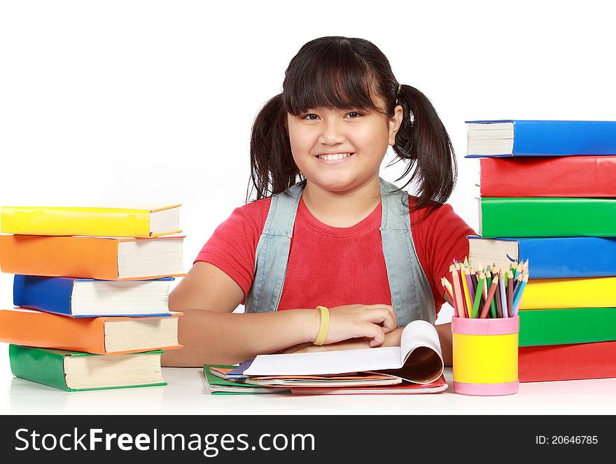 Image of schoolgirl smiling with the heap of books against white background. Image of schoolgirl smiling with the heap of books against white background