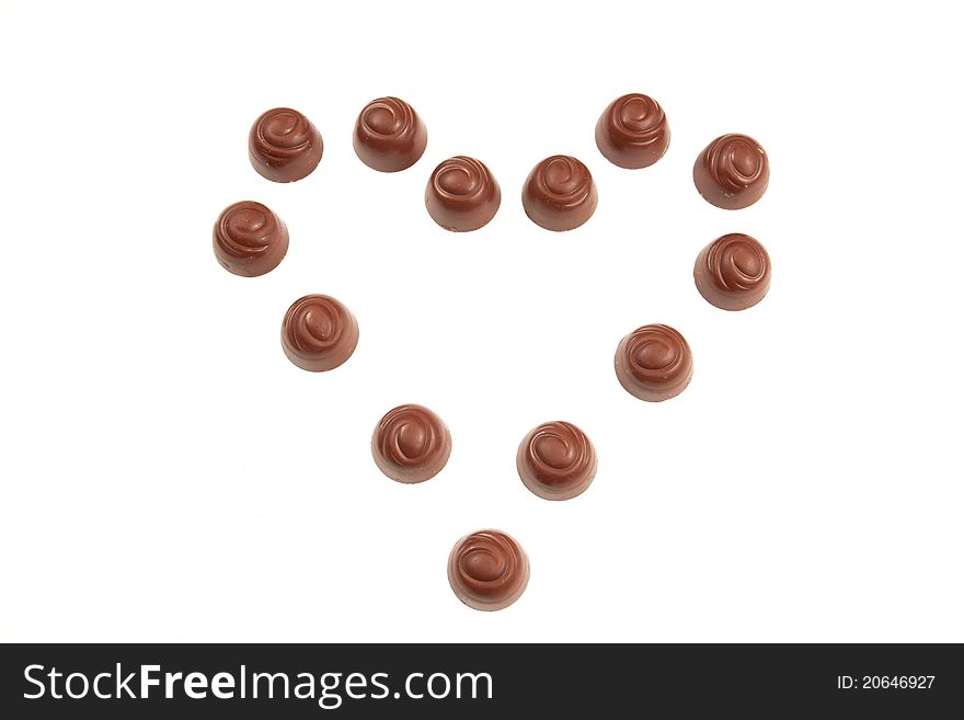 Selection of fine pralines of chocolate, placed in the shape of a heart. Selection of fine pralines of chocolate, placed in the shape of a heart