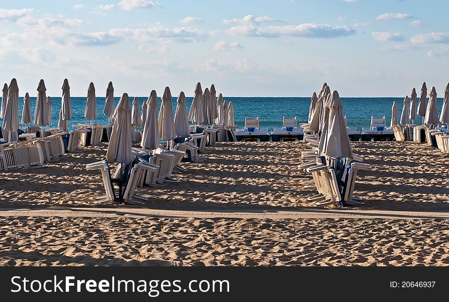 View of the beach with loungers and umbrellas. View of the beach with loungers and umbrellas.