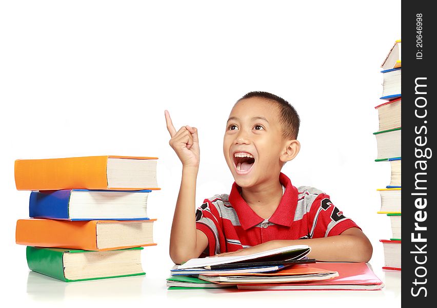 Portrait of happy joyful little boy pointing into copy space against on white background