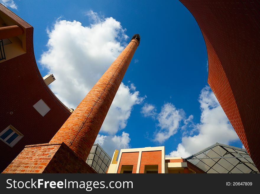 Modern Building with appartments and old chimney with nest. Modern Building with appartments and old chimney with nest