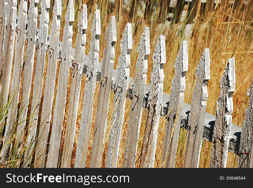 Old rickety wooden picket fence. Old rickety wooden picket fence