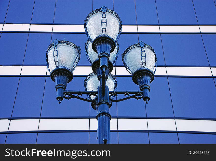 Ornate street lights with blue windows in background