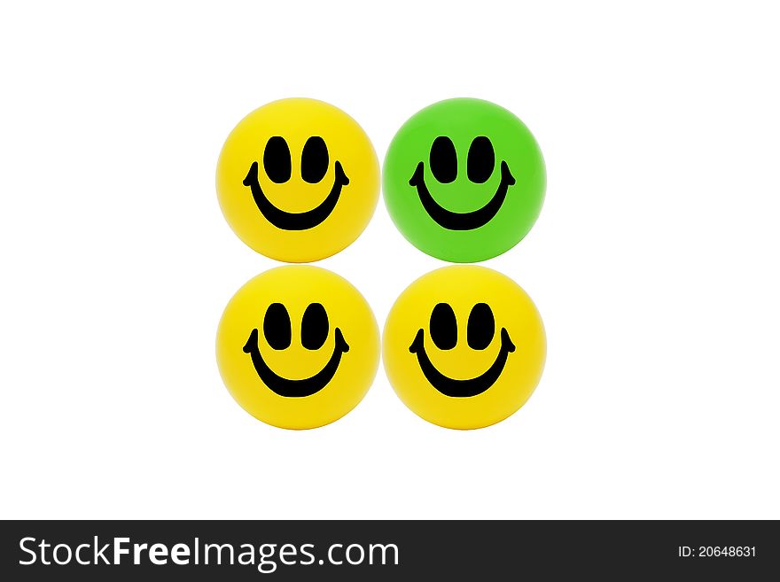 See the difference - three smiling yellow balls and one green ball