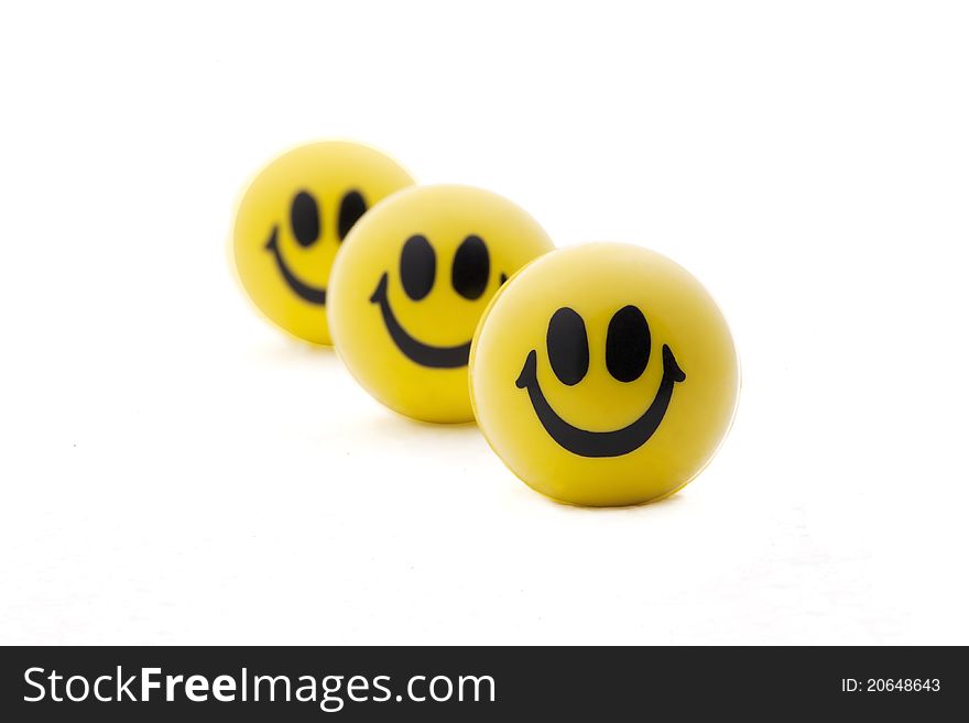 Three smiling yellow balls in order one behind. Three smiling yellow balls in order one behind.