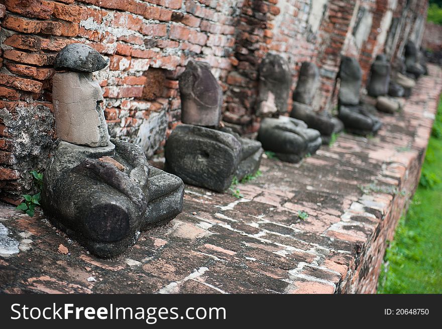 A line of Buddha statues without heads in Ayutthaya, Thailand. A line of Buddha statues without heads in Ayutthaya, Thailand