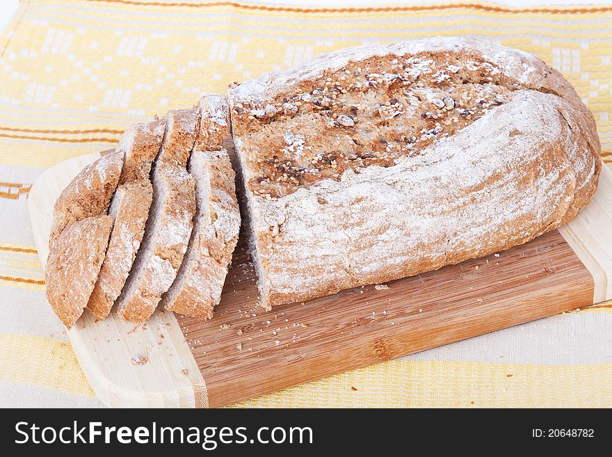 Bread on the wooden board, top view